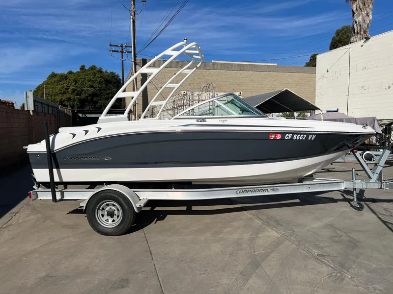 Slide: The Image of 2017 Chaparral 19 H2O Sport boat on trailer, parked outdoors. - 3