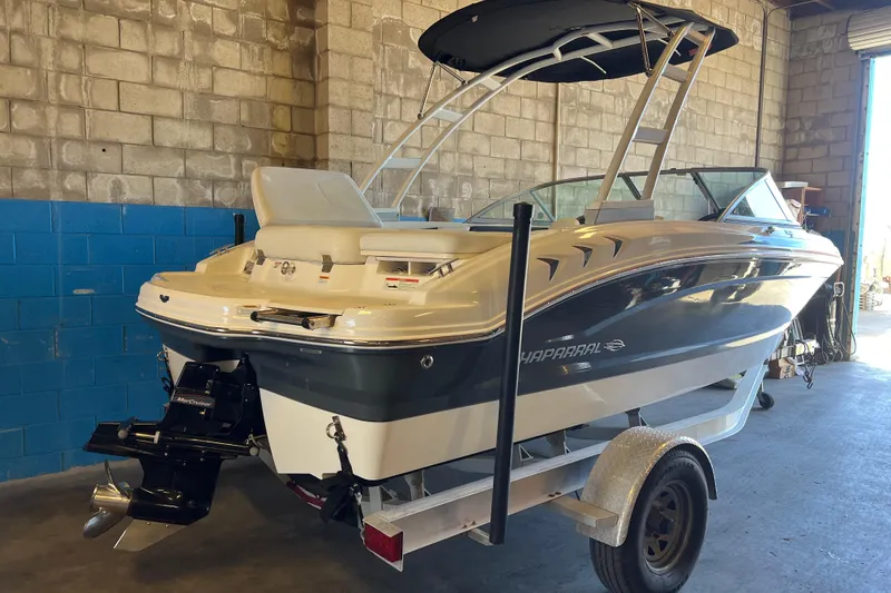Slide: The Image of 2017 Chaparral 19 H2O Sport boat on trailer in garage setting. - 4