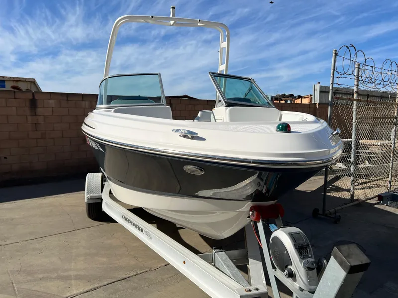 Slide: The Image of 2017 Chaparral 19 H2O Sport boat on trailer, parked outdoors. - 6