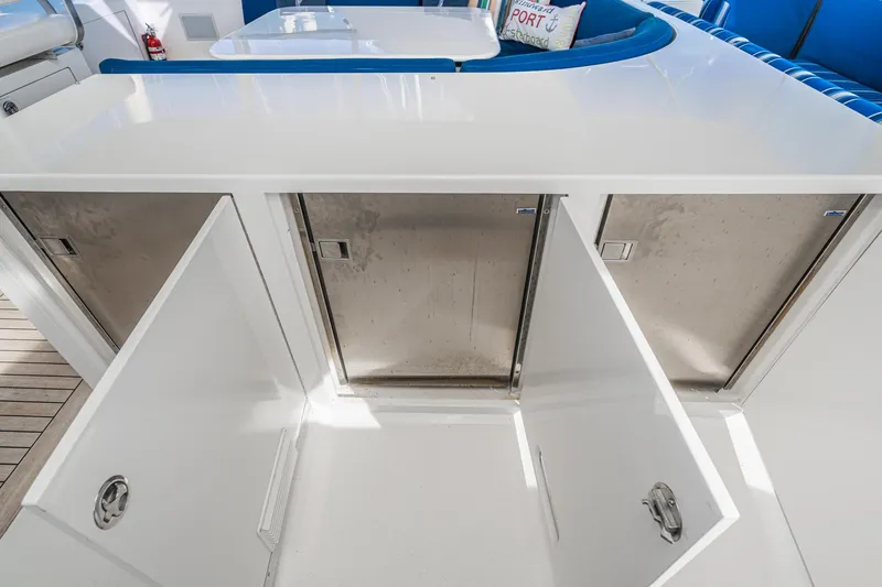 Slide: The Image of Nordlund 1995 Cockpit Motor Yacht interior with open storage compartments and blue seating. - 16