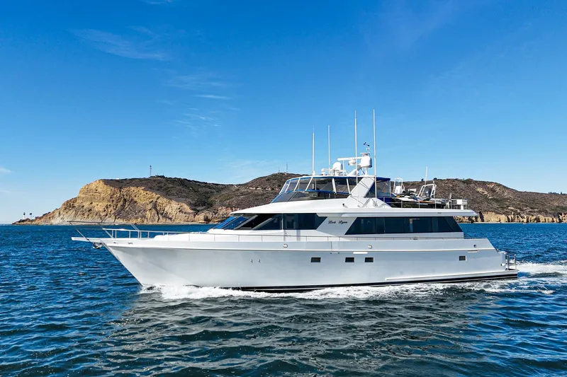 Slide: The Image of Nordlund 1995 Cockpit Motor Yacht cruising on blue ocean near rocky coastline. - 3
