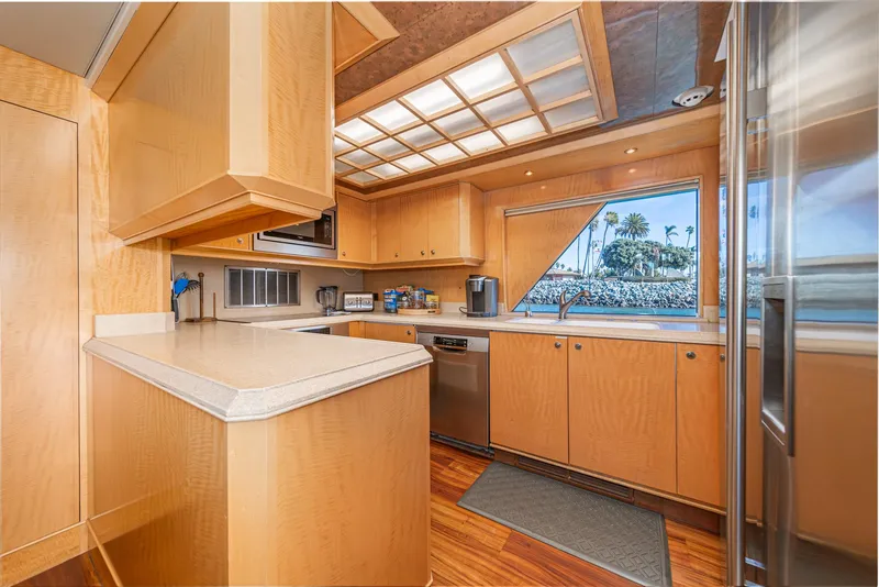 Slide: The Image of Luxurious kitchen interior of a 1995 Nordlund Cockpit Motor Yacht with modern appliances. - 32