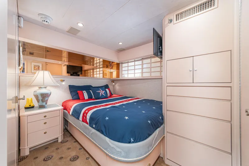 Slide: The Image of Luxurious bedroom in 1995 Nordlund Cockpit Motor Yacht with nautical-themed bedding. - 42