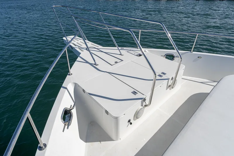 Slide: The Image of Nordlund 1995 Cockpit Motor Yacht bow with stainless steel railings on calm water. - 7