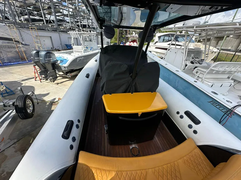 Slide: The Image of 2019 Technohull SeaDNA 999 G5 boat interior with yellow seating and covered console. - 10
