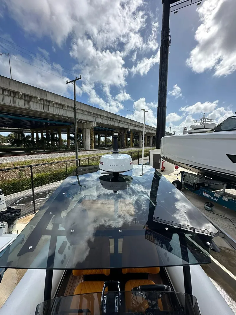 Slide: The Image of 2019 Technohull SeaDNA 999 G5 boat with sleek design under a cloudy sky. - 11