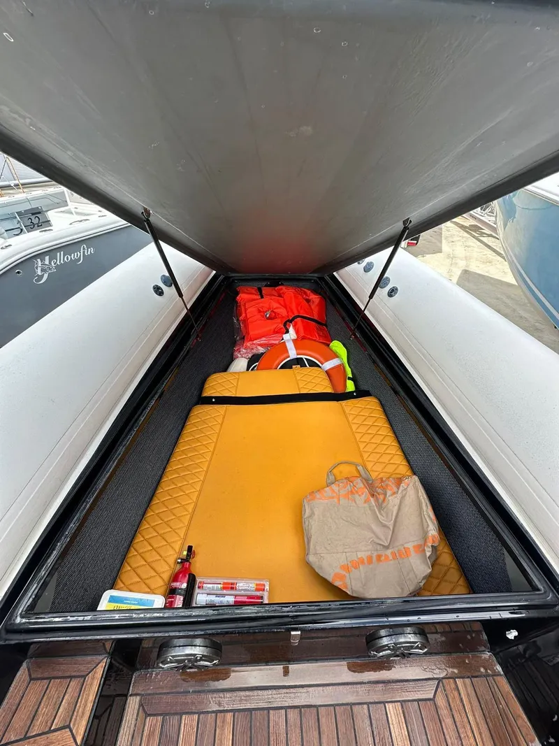 Slide: The Image of Storage compartment of 2019 Technohull SeaDNA 999 G5 with safety gear and supplies. - 12