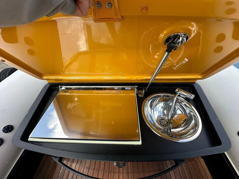 Slide: The Image of 2019 Technohull SeaDNA 999 G5 boat kitchen with sink and stove under yellow lid. - 4