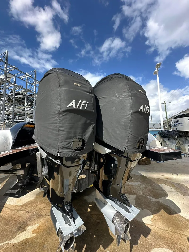 Slide: The Image of 2019 Technohull SeaDNA 999 G5 outboard motors with protective covers, under a partly cloudy sky. - 5