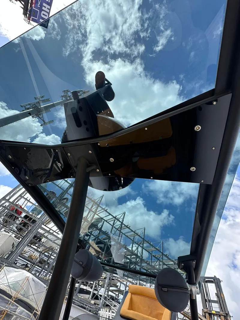 Slide: The Image of 2019 Technohull SeaDNA 999 G5 boat with reflective glass and blue sky. - 6