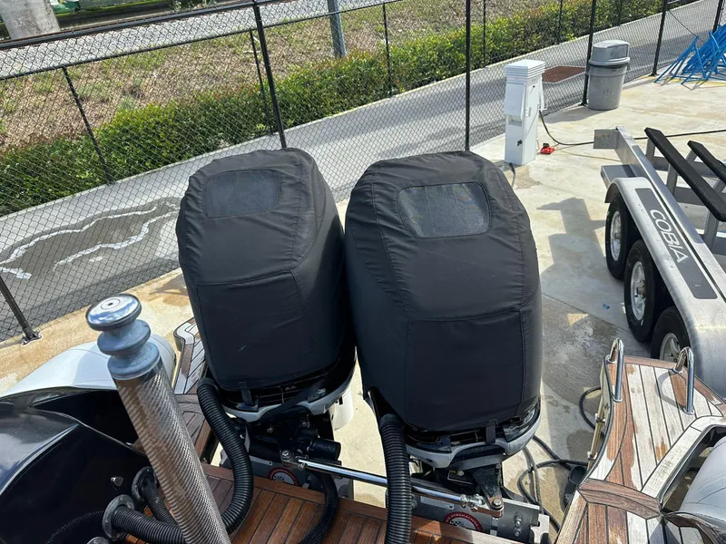 Slide: The Image of Twin outboard engines on 2019 Technohull SeaDNA 999 G5 boat, covered and docked. - 8