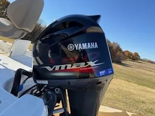 Slide: The Image of 2019 NauticStar 244XTS boat with 250 horsepower engine, docked outdoors. - 11