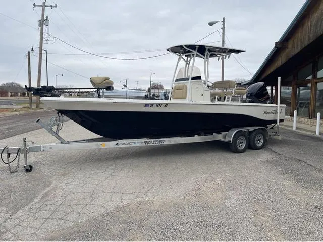 Slide: The Image of 2019 NauticStar 244XTS boat on trailer in parking lot. - 13