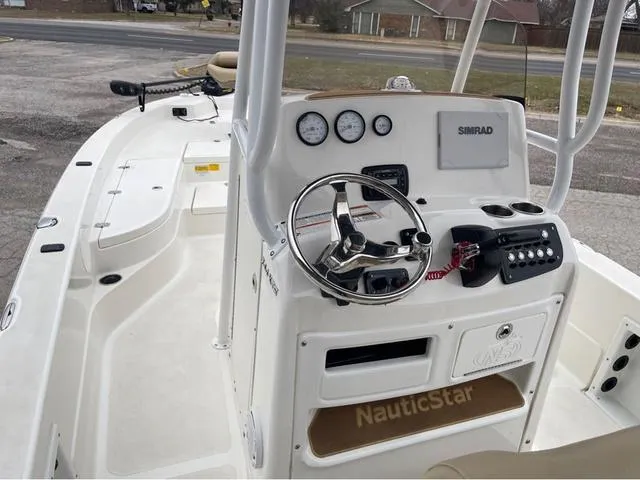 Slide: The Image of 2019 NauticStar 244XTS boat console with steering wheel and Simrad display. - 22