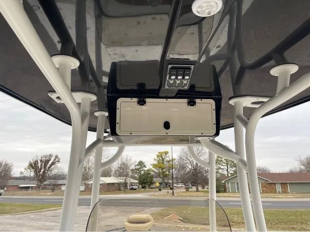 Slide: The Image of 2019 NauticStar 244XTS boat console with overhead storage and controls. - 24
