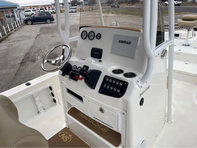 Slide: The Image of 2019 NauticStar 244XTS boat console with steering wheel and Simrad display. - 25