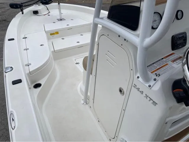 Slide: The Image of 2019 NauticStar 244XTS boat interior, featuring console and seating area. - 30