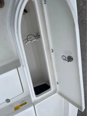 Slide: The Image of Open storage compartment on 2019 NauticStar 244XTS boat. - 33