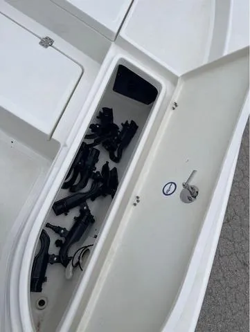 Slide: The Image of 2019 NauticStar 244XTS boat storage compartment with fishing rod holders. - 34
