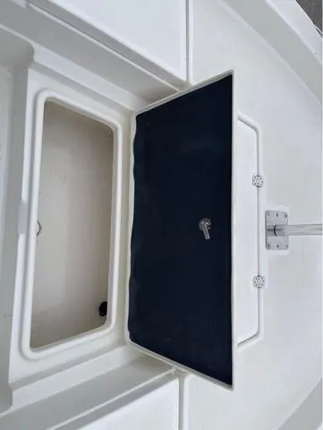 Slide: The Image of 2019 NauticStar 244XTS boat storage compartment with open hatch. - 35