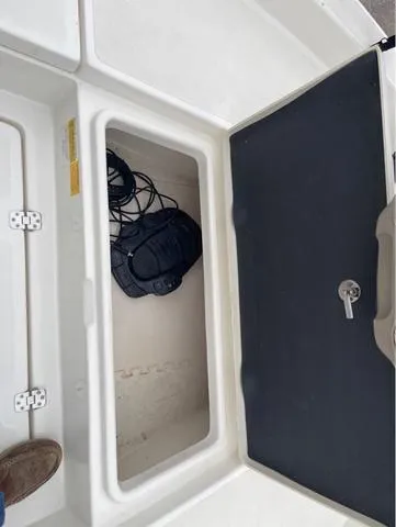 Slide: The Image of Open storage compartment on 2019 NauticStar 244XTS boat. - 36