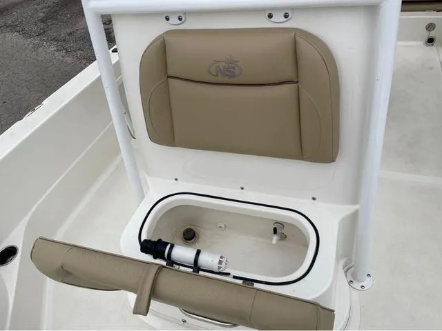 Slide: The Image of 2019 NauticStar 244XTS boat seat with storage compartment and beige cushion. - 39