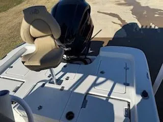 Slide: The Image of Close-up of 2019 NauticStar 244XTS boat engine and trailer in water. - 8