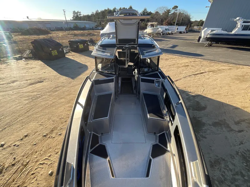 Slide: The Image of 2023 Viggo C8 boat with sleek design, docked outdoors under clear sky. - 15