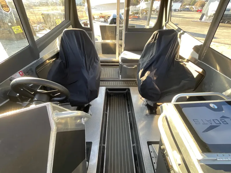 Slide: The Image of Interior of 2023 Viggo C8 boat with covered seats and modern dashboard. - 20