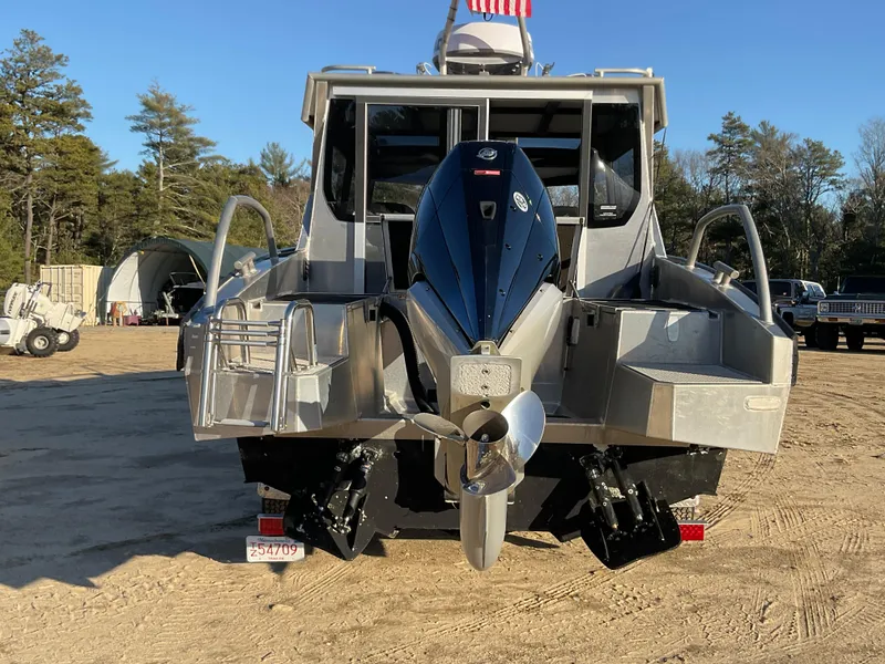 Slide: The Image of 2023 Viggo C8 boat with powerful outboard motor, parked on sandy terrain. - 3