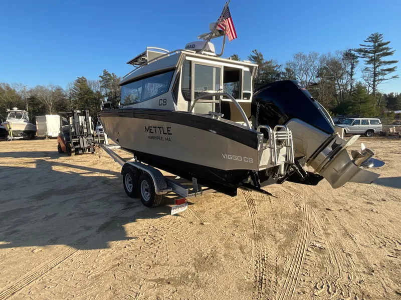 Slide: The Image of 2023 Viggo C8 boat on trailer, outdoor setting, American flag, sunny day. - 6