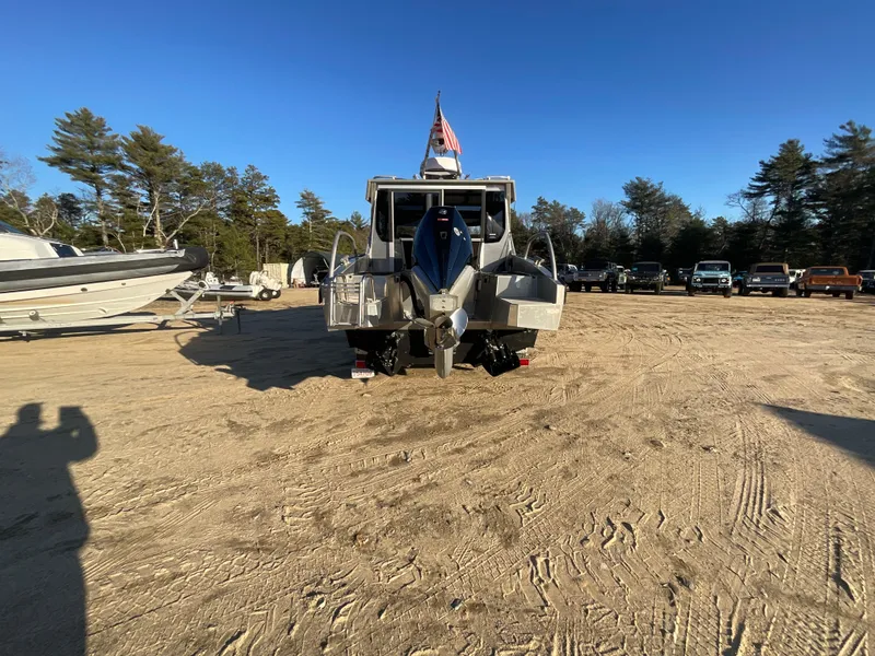 Slide: The Image of 2023 Viggo C8 boat parked on sandy lot with clear blue sky. - 8