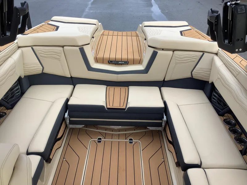 Slide: The Image of Luxurious interior of 2025 Nautique G23 boat with beige seating and teak flooring. - 15