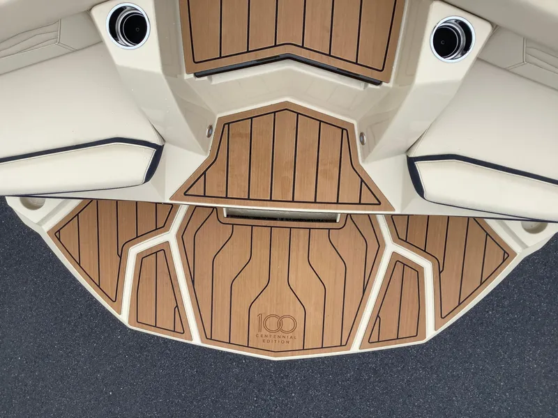 Slide: The Image of 2025 Nautique G23 Centennial Edition boat deck with wood finish. - 9