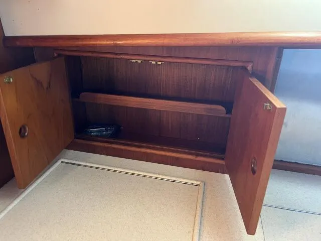 Slide: The Image of Open wooden cabinet inside 1999 Grand Banks Eastbay 38 yacht. - 10