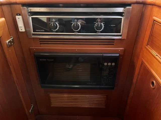 Slide: The Image of 1999 Grand Banks Eastbay 38 galley with stove and microwave. - 12