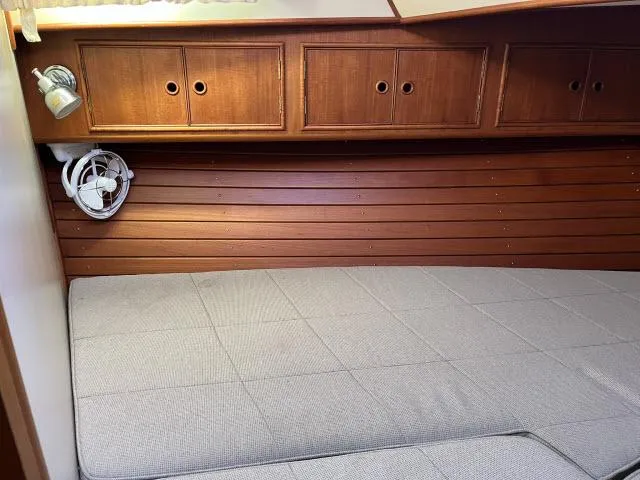Slide: The Image of Cozy cabin interior of 1999 Grand Banks Eastbay 38 with wooden cabinets and bed. - 21