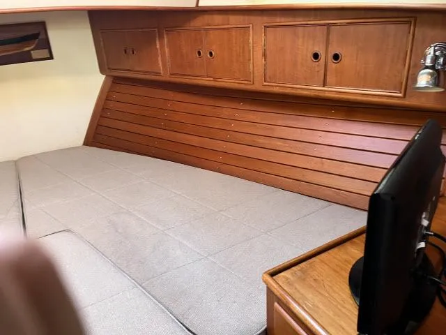 Slide: The Image of Cozy cabin interior of 1999 Grand Banks Eastbay 38 with wooden cabinetry and bed. - 22
