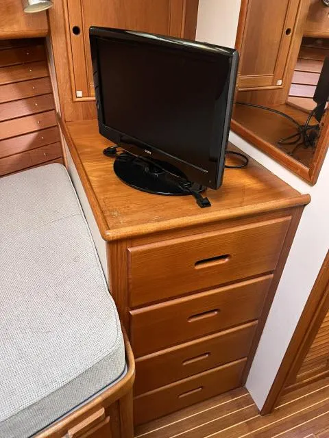 Slide: The Image of Wooden interior of 1999 Grand Banks Eastbay 38 with TV and drawers. - 23