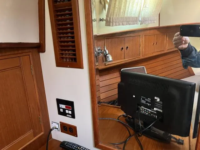 Slide: The Image of Interior of 1999 Grand Banks Eastbay 38 with wood paneling and mounted electronics. - 25