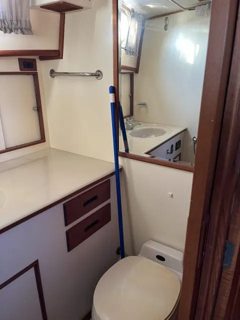 Slide: The Image of Bathroom interior of 1999 Grand Banks Eastbay 38 yacht with sink and toilet. - 30