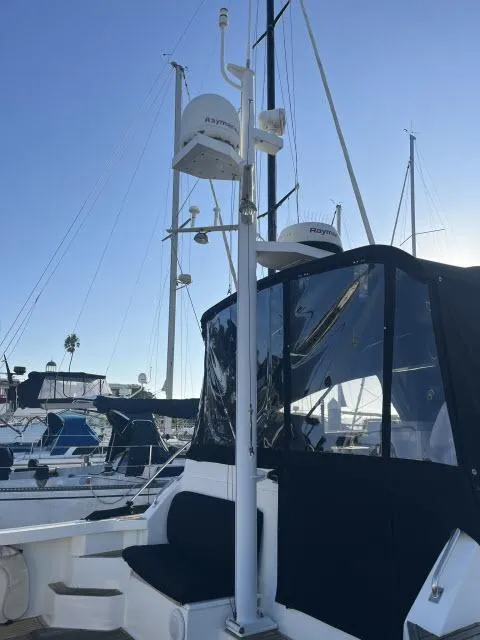 Slide: The Image of 1999 Grand Banks Eastbay 38 yacht with radar equipment in a marina setting. - 36