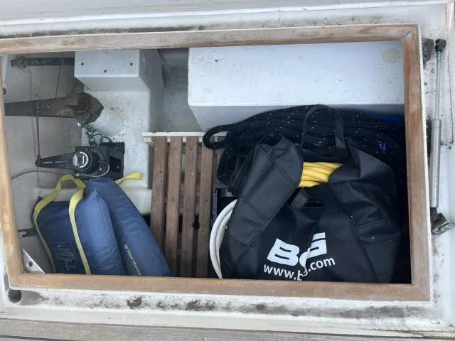 Slide: The Image of Storage compartment on a 1999 Grand Banks Eastbay 38 with boating gear and accessories. - 38