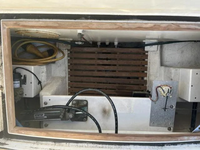 Slide: The Image of 1999 Grand Banks Eastbay 38 engine compartment with cables and wooden slats. - 39