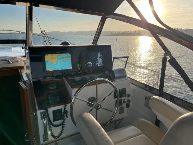 Slide: The Image of Interior view of 1999 Grand Banks Eastbay 38 yacht helm at sunset. - 45