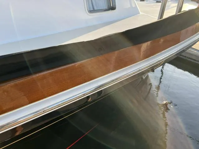 Slide: The Image of 1999 Grand Banks Eastbay 38 boat with polished wood and sleek design. - 50