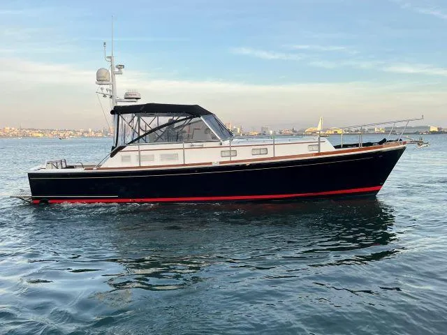 The Image of 1999 Grand Banks Eastbay 38 yacht on calm water. - 0