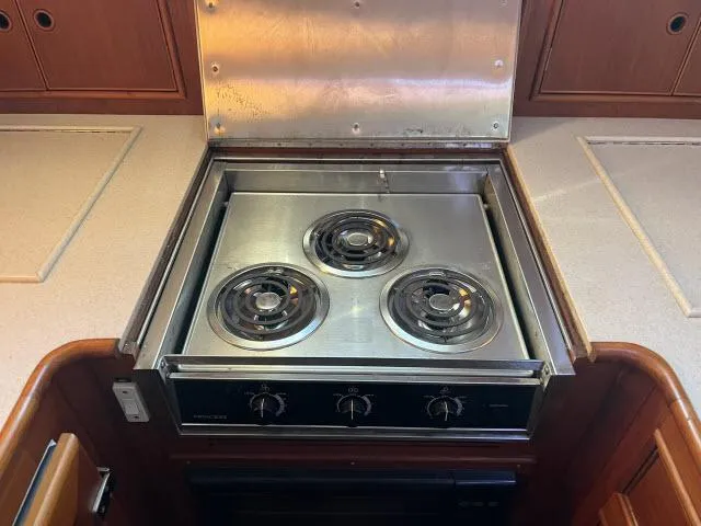 Slide: The Image of Stainless steel stove with three burners in a 1999 Grand Banks Eastbay 38 yacht kitchen. - 11