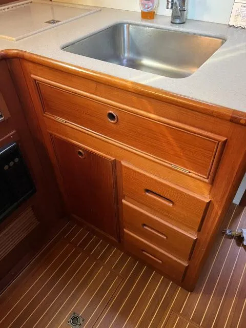 Slide: The Image of Wooden kitchen cabinetry with sink in 1999 Grand Banks Eastbay 38 yacht. - 15