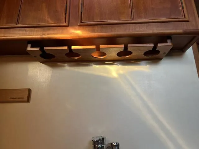 Slide: The Image of Wooden cabinet with under-shelf lighting in a 1999 Grand Banks Eastbay 38 yacht. - 16